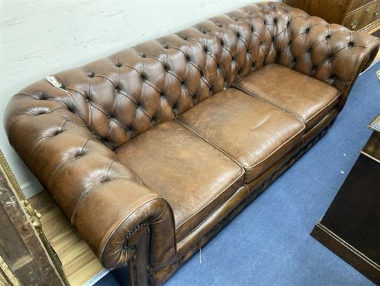 A Victorian style buttoned brown leather three seater Chesterfield settee, width 200cm, depth 84cm, height 66cm